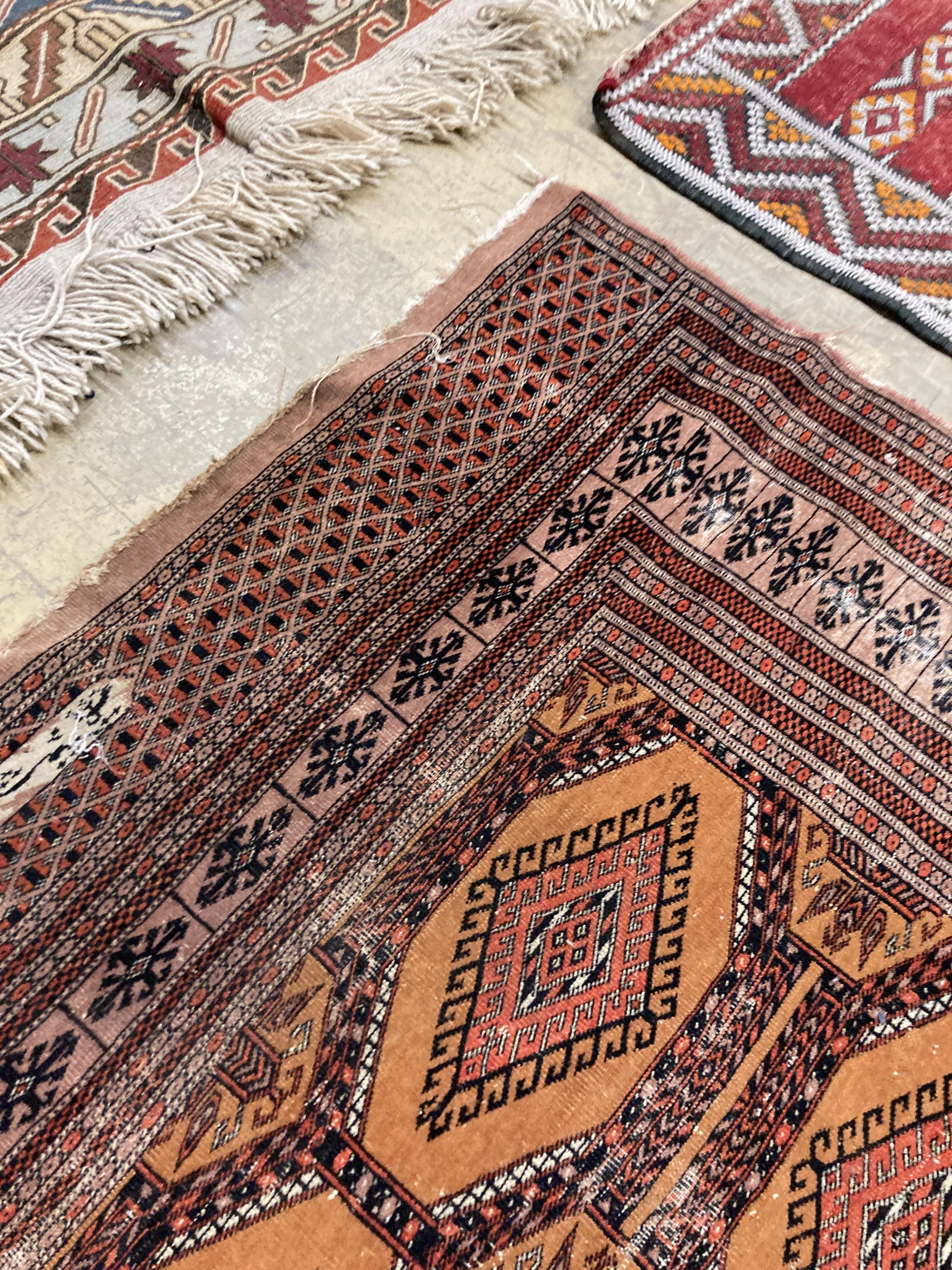 A Bokhara orange ground rug 198 x 125 cms, a smaller Anatolian flat weave rug and Bokhara prayer mat.